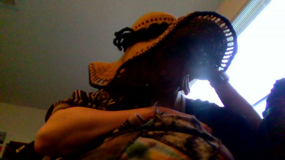 Me, in a yellow and dark blue wide-brim floppy hat.